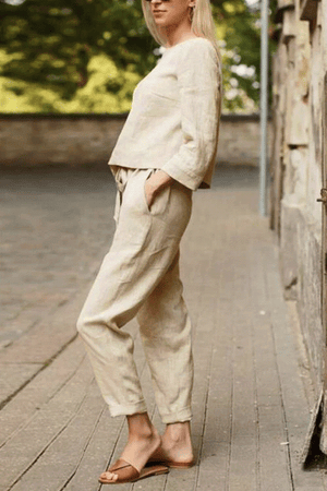 Woman wearing a 100% cotton linen monochrome two-piece set with loose-fitting top and pants.