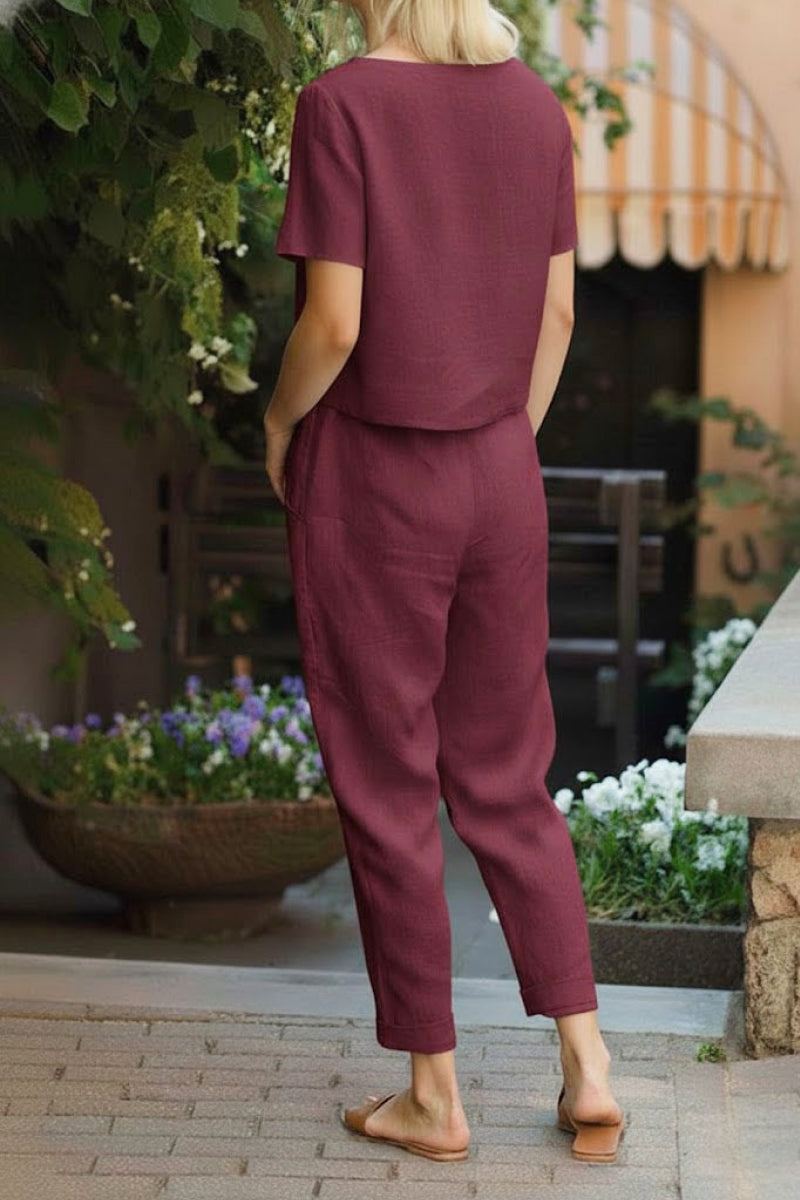 Woman wearing relaxed fit maroon cotton linen set with short-sleeve top and straight-leg pants outdoors