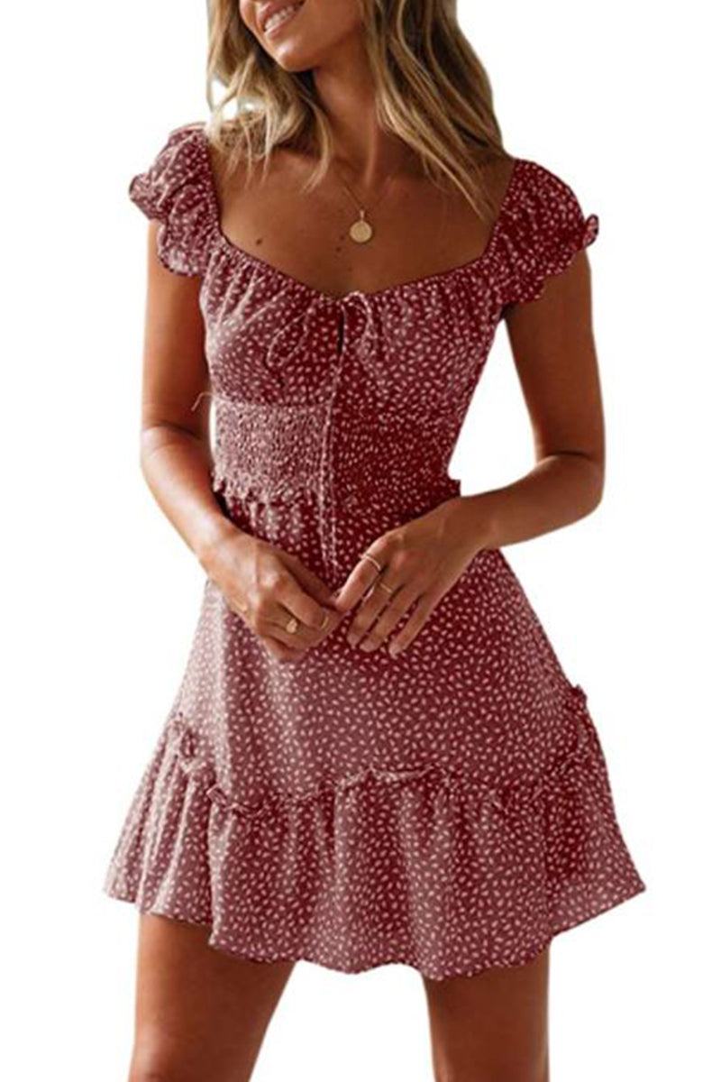 Woman wearing a sweetheart collar printed ruffled maxi dress in soft cotton with ruffle sleeves and a high waist design.