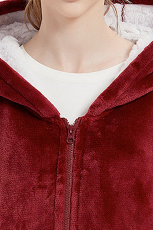 Close-up of oversized ultra soft hooded blanket zipper detail in burgundy with white sherpa lining