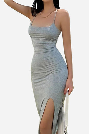Woman wearing a grey elegant side slit midi dress with slim straps and flattering fitted silhouette