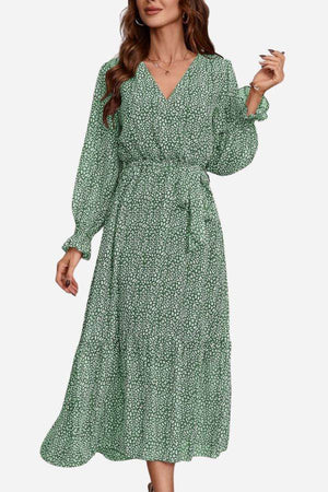 Green floral Bloom Wrap Midi Dress with long trumpet sleeves and A-line silhouette on model