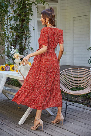 Woman wearing a red Charming Floral Boho Maxi Dress with short sleeves and flowing skirt outdoors on patio