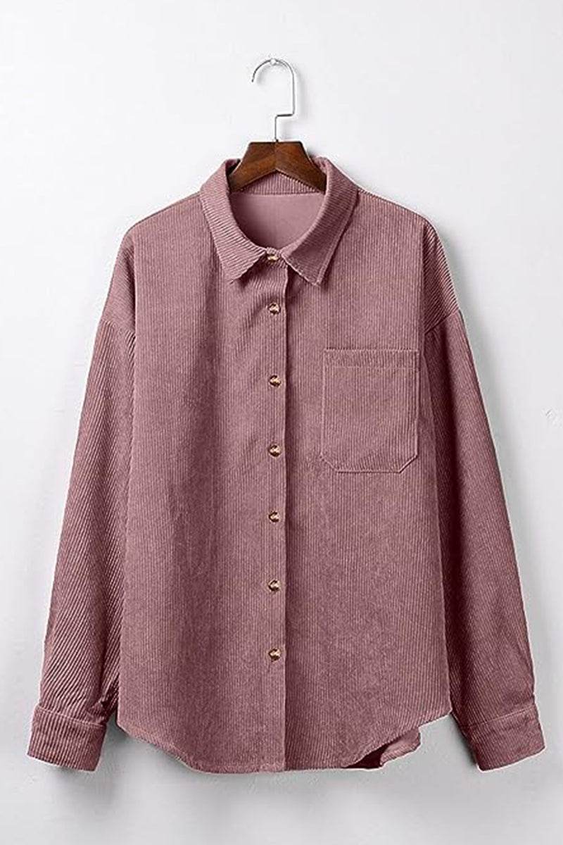 Sleek suede oversized button-down shirt in mauve with front pocket and button closure hanging on wooden hanger