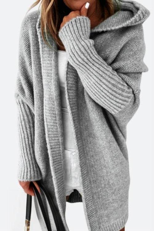 Warm oversized hooded cardigan in soft knit fabric with long ribbed sleeves and relaxed fit