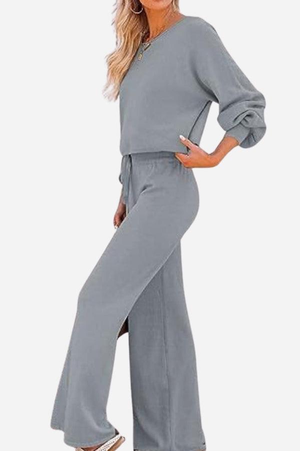 Woman wearing gray round neck loose fit cozy two-piece set with long sleeves and wide-leg pants