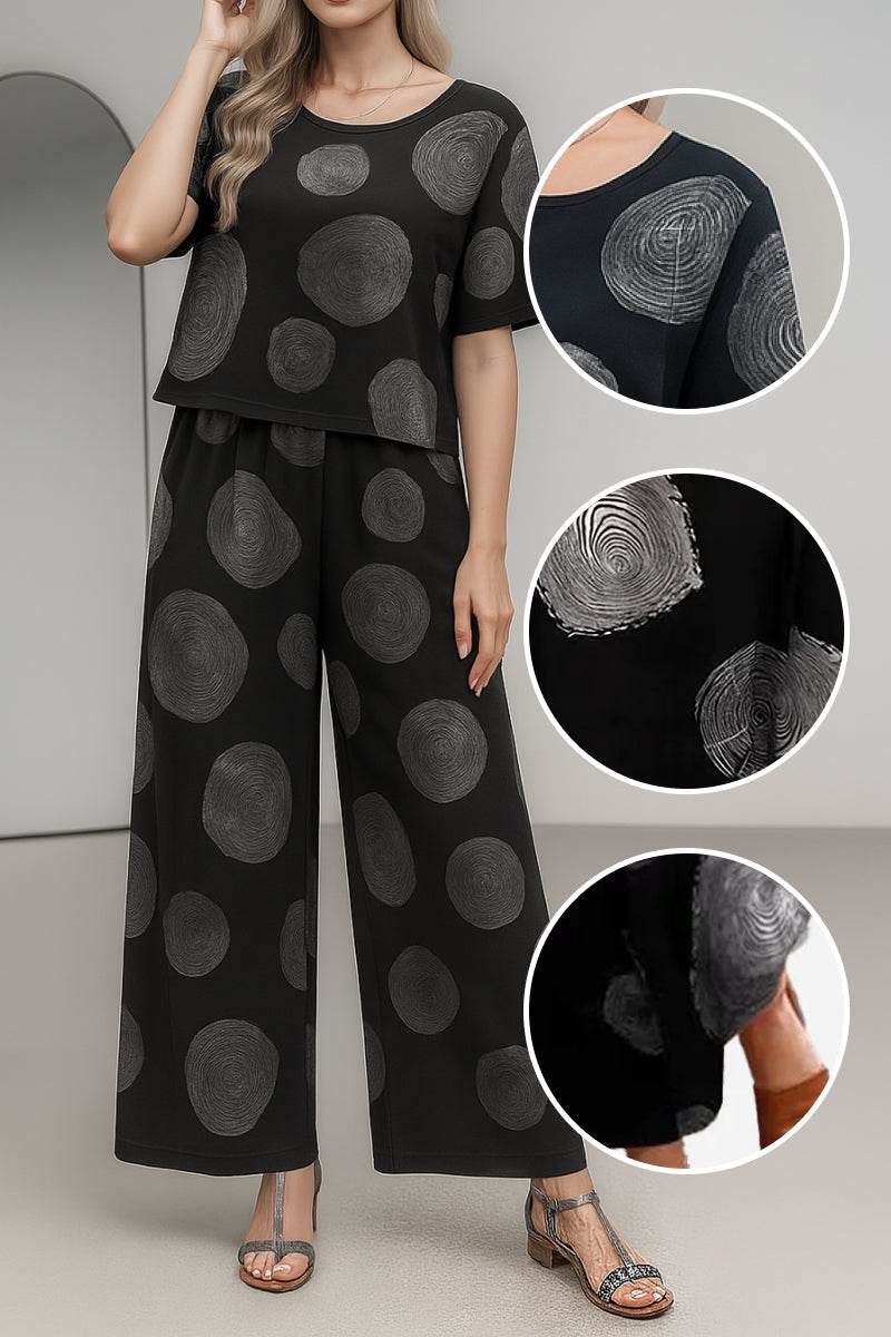 Black loose fit co-ord set with wide-leg pants and short-sleeve top featuring circular patterns