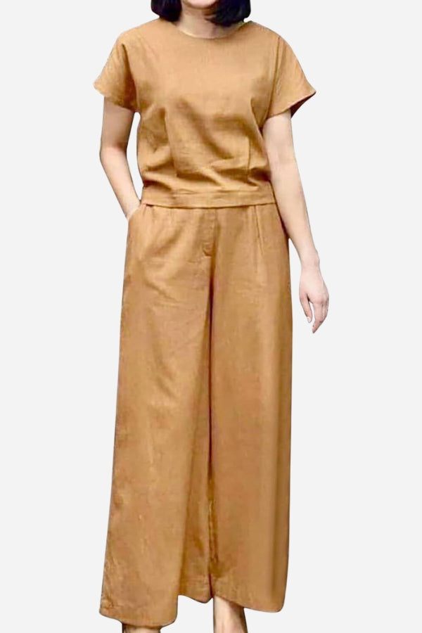 Woman wearing a tan short-sleeved bell pants two-piece set with a loose top and wide-leg pants