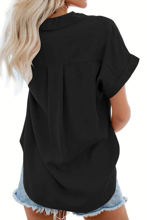 black V-neck collared button blouse with rolled short sleeves worn with denim shorts, back view