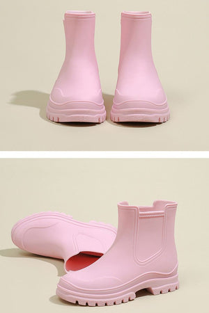 Pink non-slip rain boots with SuperGrip soles and waterproof design.