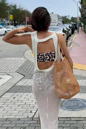 Woman carrying a beige Breezy Mesh Tote Bag on city sidewalk, showcasing lightweight, breathable polyester netting design.