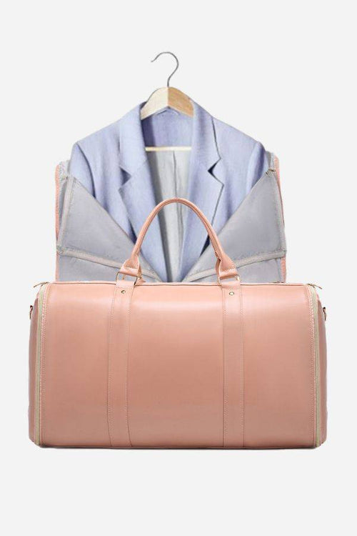 Pink no-wrinkle foldable travel bag with open garment compartment and hanging suit inside.
