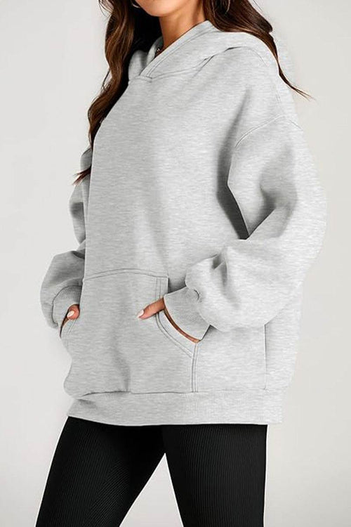Oversized fleece-lined hoodie in light gray with front pocket and relaxed fit for cozy warmth and travel comfort