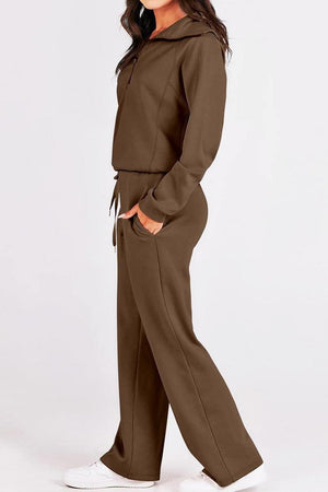 Woman wearing brown Loungewear Buttersoft Tracksuit Set with relaxed fit and white sneakers.