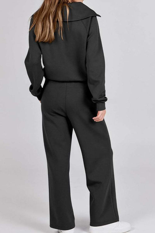 Woman wearing black Loungewear Buttersoft Tracksuit Set showing back view, cozy oversized fit.