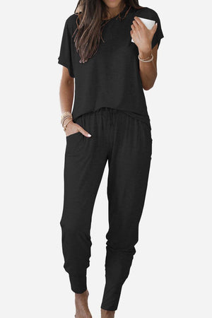 woman wearing black ultra-soft two-piece loungewear set with batwing sleeves and jogger pants with pockets