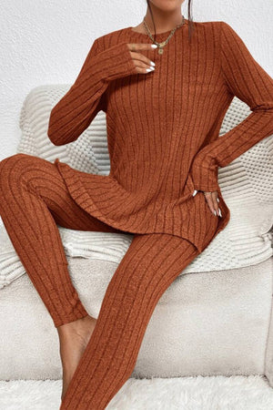 Woman wearing rust-colored Butter Touch Ribbed Two-Piece Set with long sleeve top and matching ribbed pants sitting on a beige couch