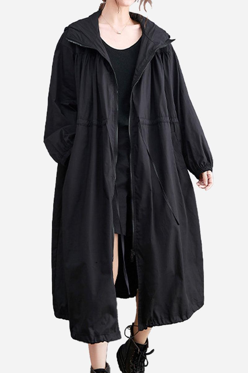 Black oversized all-weather water-resistant windbreaker with hood and drawstrings, styled for comfort and breathability in any weather
