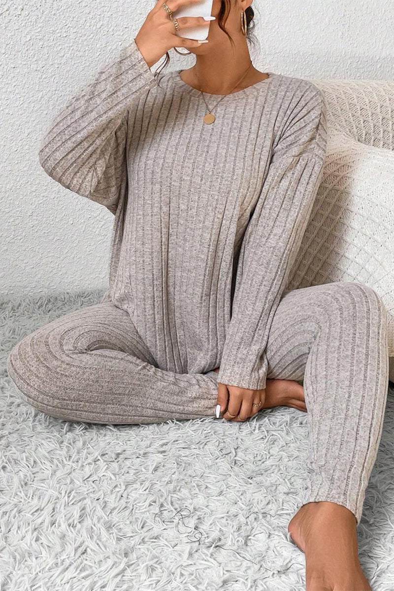 Woman wearing beige Body Confident Oversized Knit two-piece loungewear set sitting on carpet