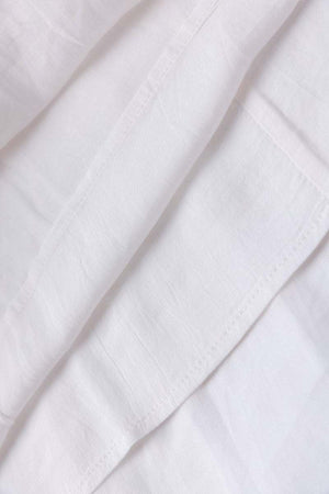 close-up of white 100% linen fabric texture for coastal shift dress