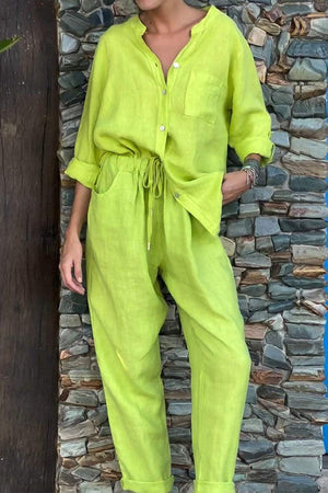 Lime green casual chic two-piece set with button-up top and drawstring pants against stone wall background
