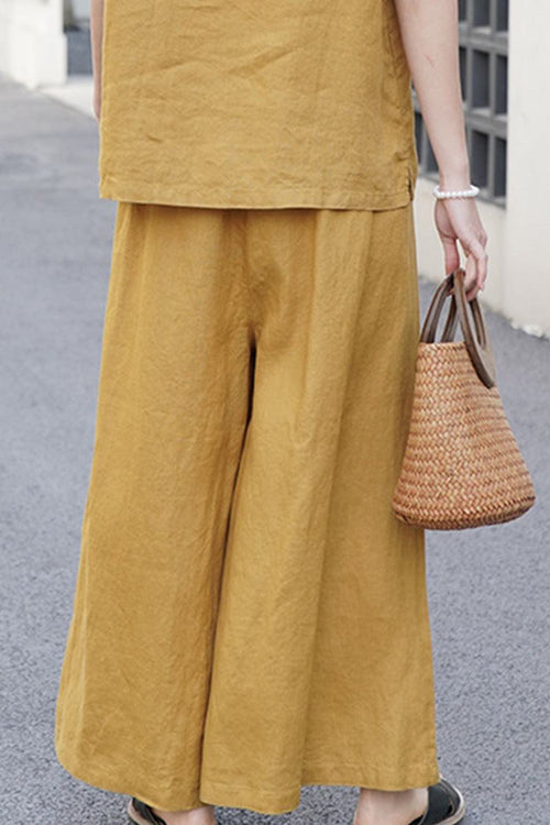 Mustard yellow wide-leg pants made from 100% linen for breathable, comfortable wear.