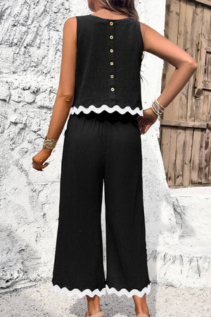 Black scalloped trim sleeveless top and wide leg pants set with button back and white scalloped edges.