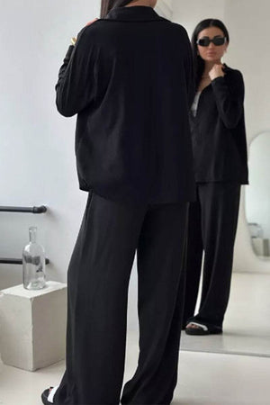 Black relaxed fit wide-leg two-piece set for travel with wrinkle-resistant polyester fabric.