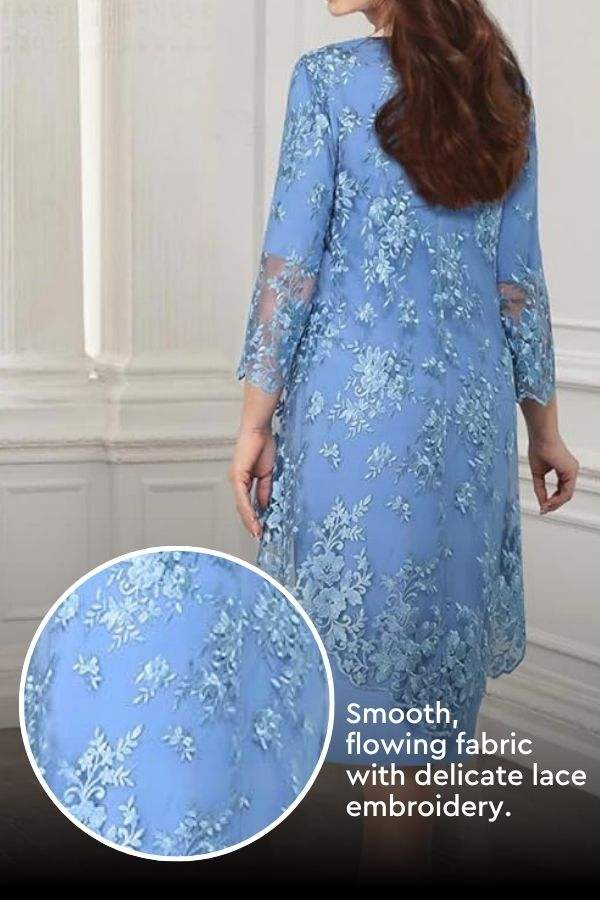 Back view of elegant blue two-piece evening dress with lace embroidery and flowing fabric