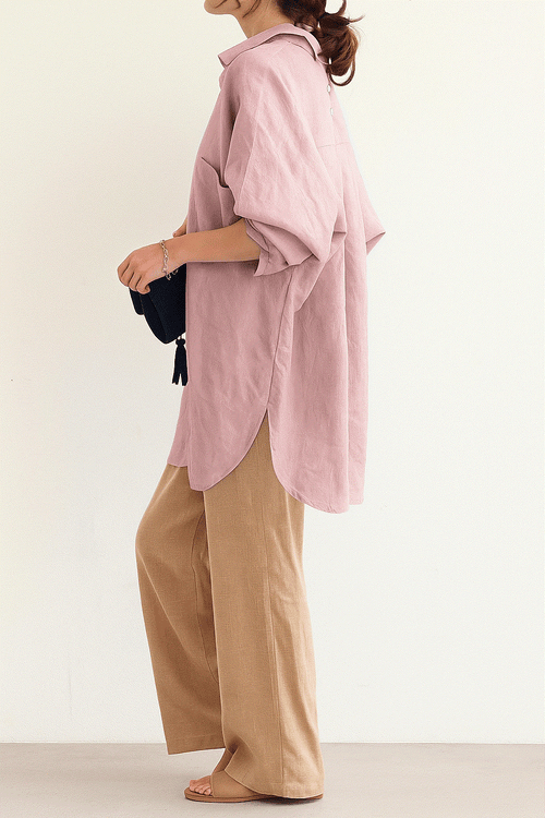 Woman wearing Linen Breeze Set with a pink oversized linen-cotton shirt and beige high-waist palazzo pants.