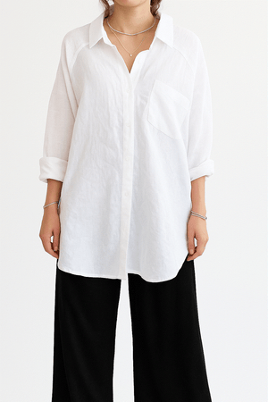 Woman wearing white linen-cotton blend relaxed shirt and black high-waist palazzo pants, Linen Breeze Set summer outfit