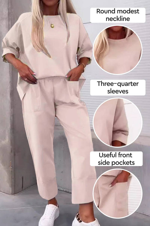 Beige two-piece set with round modest neckline, three-quarter sleeves, and front side pockets, styled with white sneakers.