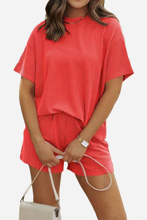 Woman wearing a relaxed fit red textured short-sleeve top and matching shorts set for slow mornings