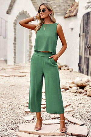 Woman wearing green sleeveless cropped top and wide-leg pants Villa Lounge Linen Set outdoors