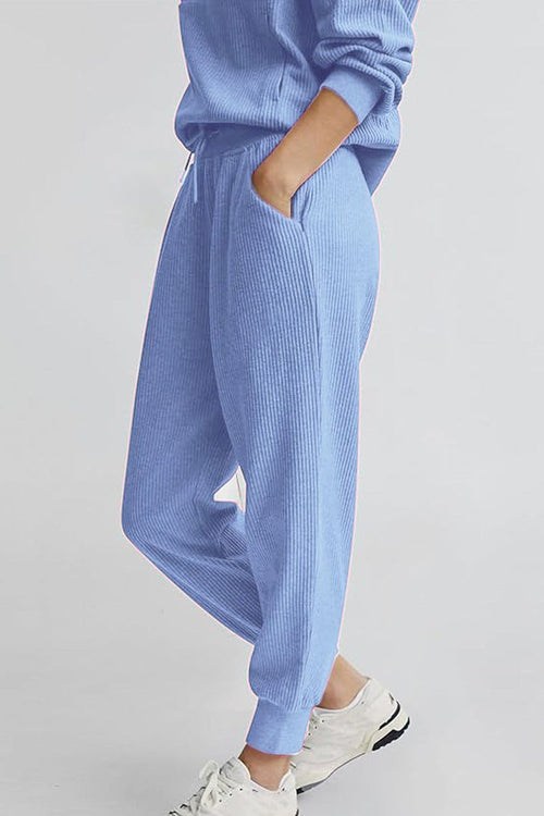 Unisex half-zip pullover and sweatpants set in soft blue polyester blend for casual comfort and style