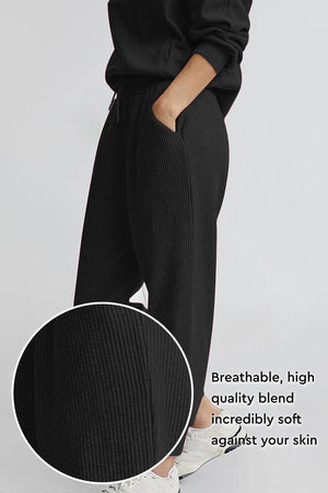 Unisex half-zip pullover and sweatpants set in breathable soft black polyester blend