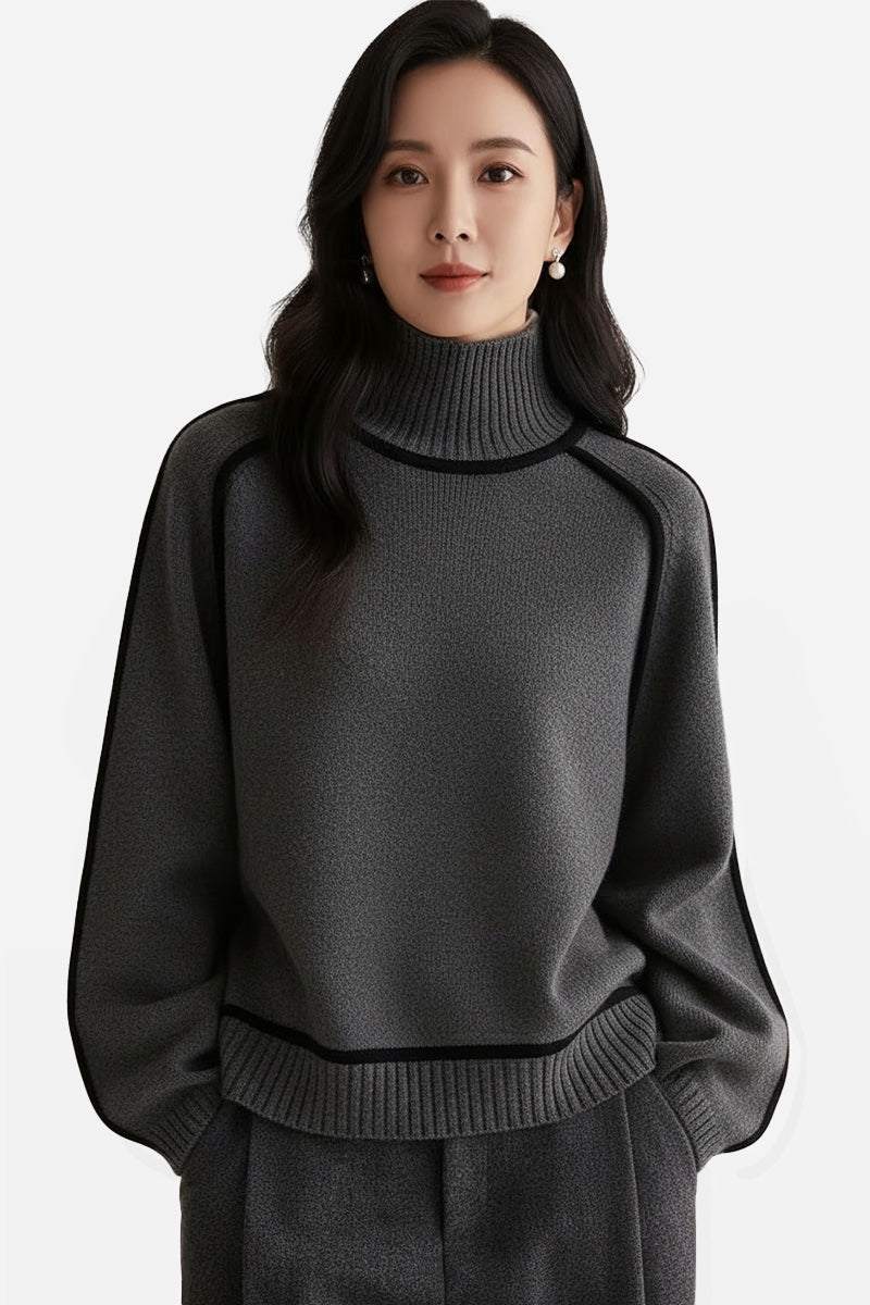 Woman wearing dark gray Zero Itch Turtleneck Sweater with contrast trim and relaxed fit