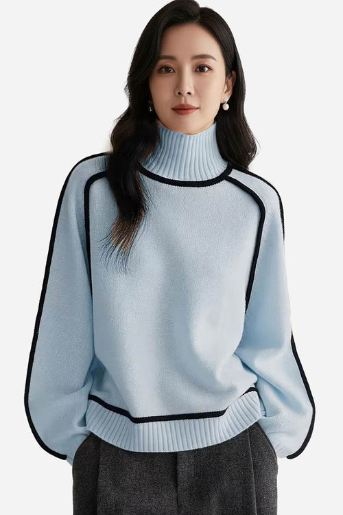 Woman wearing a light blue Zero Itch Turtleneck Sweater with black contrast trim and relaxed fit