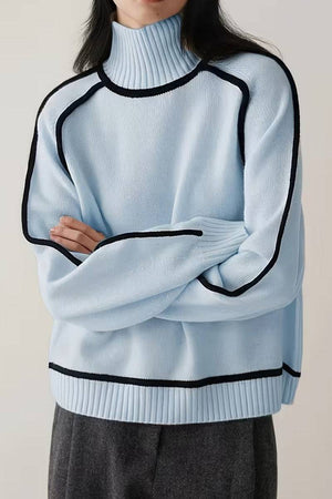 Light blue Zero Itch Turtleneck Sweater with black contrast trim, soft knit, relaxed modern fit, and slimming silhouette