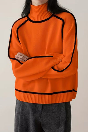 Orange Zero Itch Turtleneck Sweater with black contrast trim, soft knit, and relaxed fit