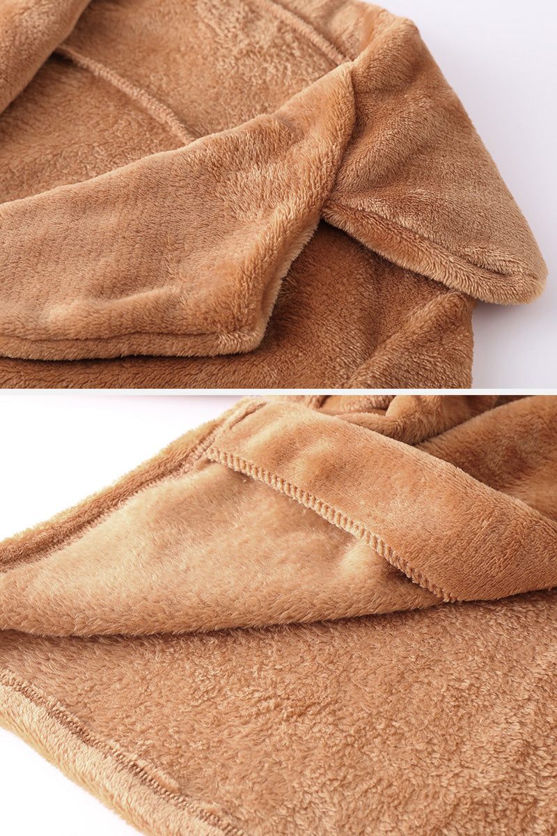 Close-up of soft brown faux fur fabric and draped collar of open front oversized fur jacket
