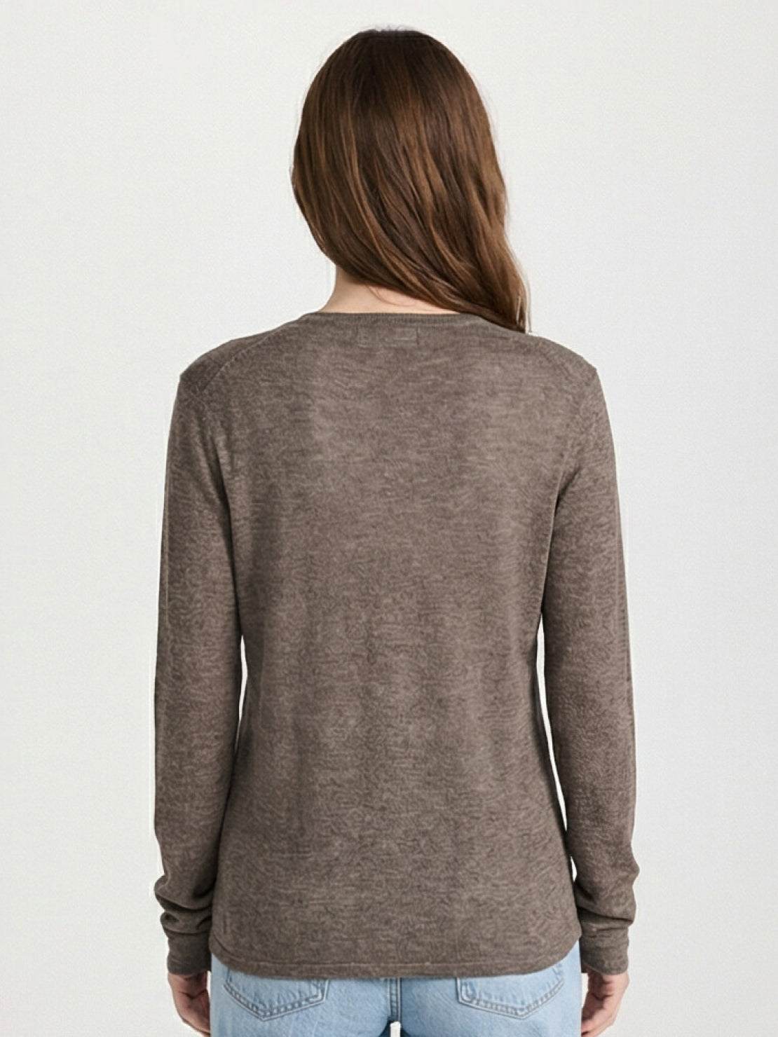 Organic linen Henley top in neutral hue with fine knit, 3-button placket, long sleeves, and side slits for breathable, relaxed fit.