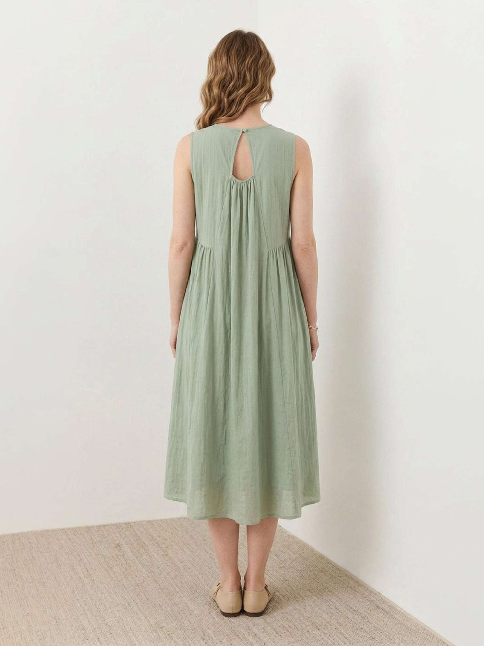 Sleeveless cotton linen pleated midi dress with pintuck bodice and A-line calf-length skirt
