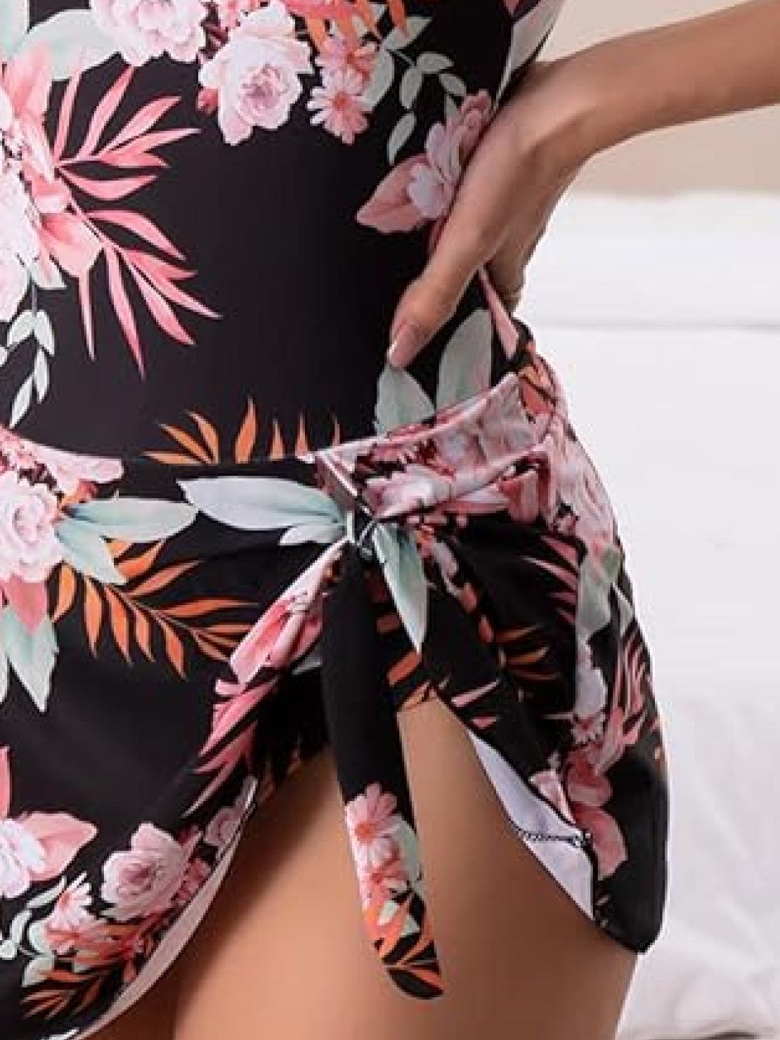 Fitted ruched wrap one-piece swimdress with adjustable straps and tie-front skirt for full coverage and comfort