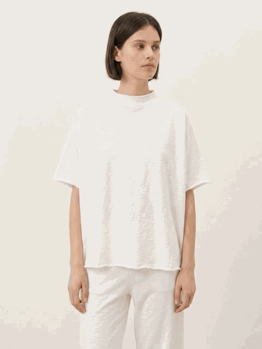 Woman wearing cotton-blend capelet lounge set with batwing sleeves and wide-leg pants in soft fabric