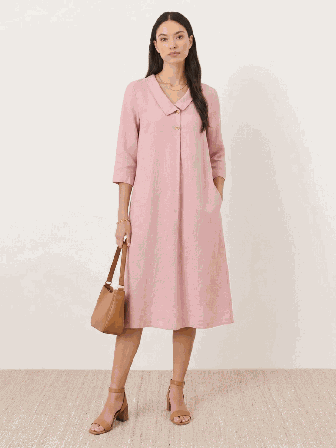 Woman wearing a relaxed fit linen-look midi dress with 3/4 sleeves and side pockets in navy