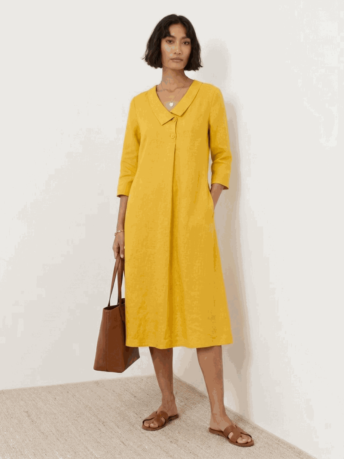 Woman wearing a linen-look midi dress with a relaxed fit and blazer-inspired neckline