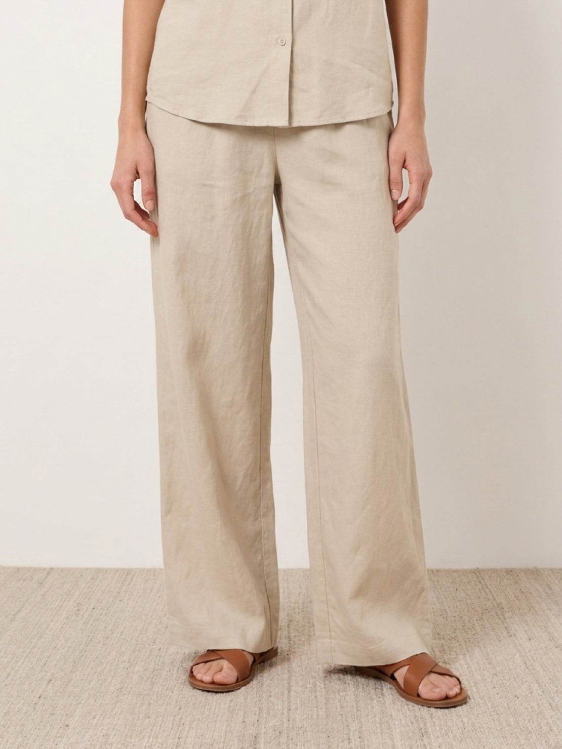 woman wearing relaxed 100% cotton two-piece set with button-front top and wide-leg pants
