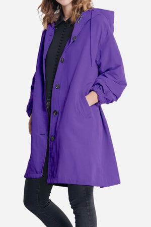 Purple water resistant oversized windbreaker jacket with hood and button closure for women