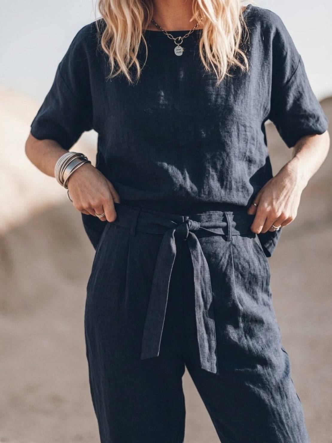 Woman wearing relaxed cotton-linen set with short-sleeve top and straight-leg pants in soft monochrome hues